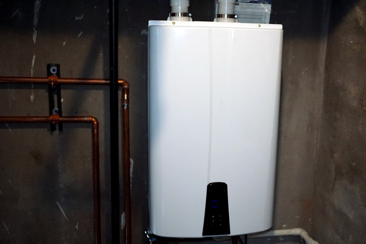 A tankless water heater installed in a space-saving storage area