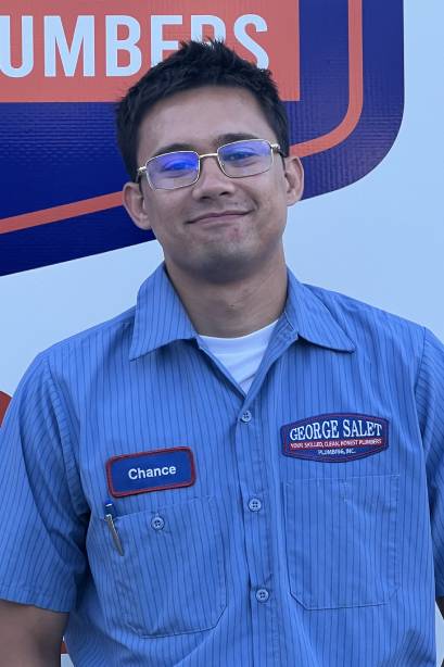 A Man Wearing Sunglasses And A Blue Shirt